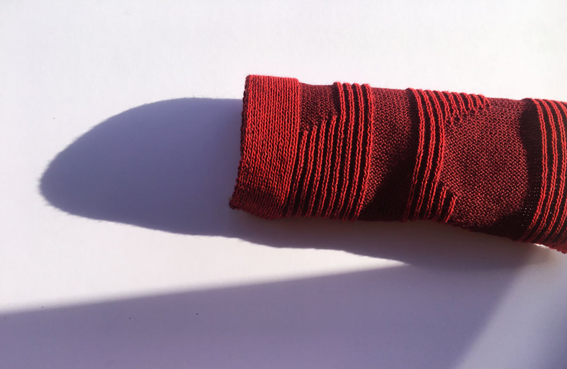 Development sample using a combination of Mock Rib and Plaiting to achieve this irregular and linear knit.